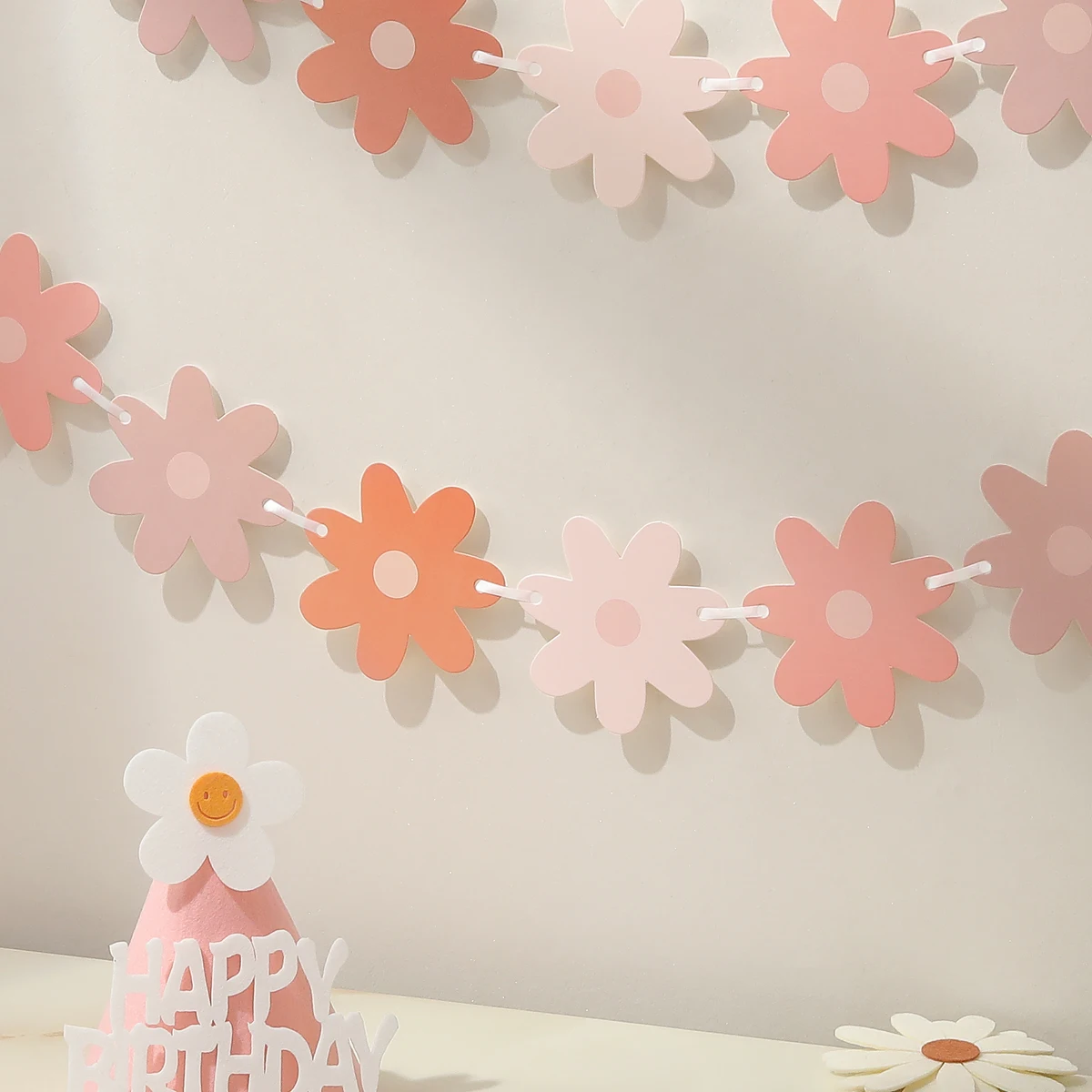 Gradient daisies pull the banner to decorate the holiday party decorations