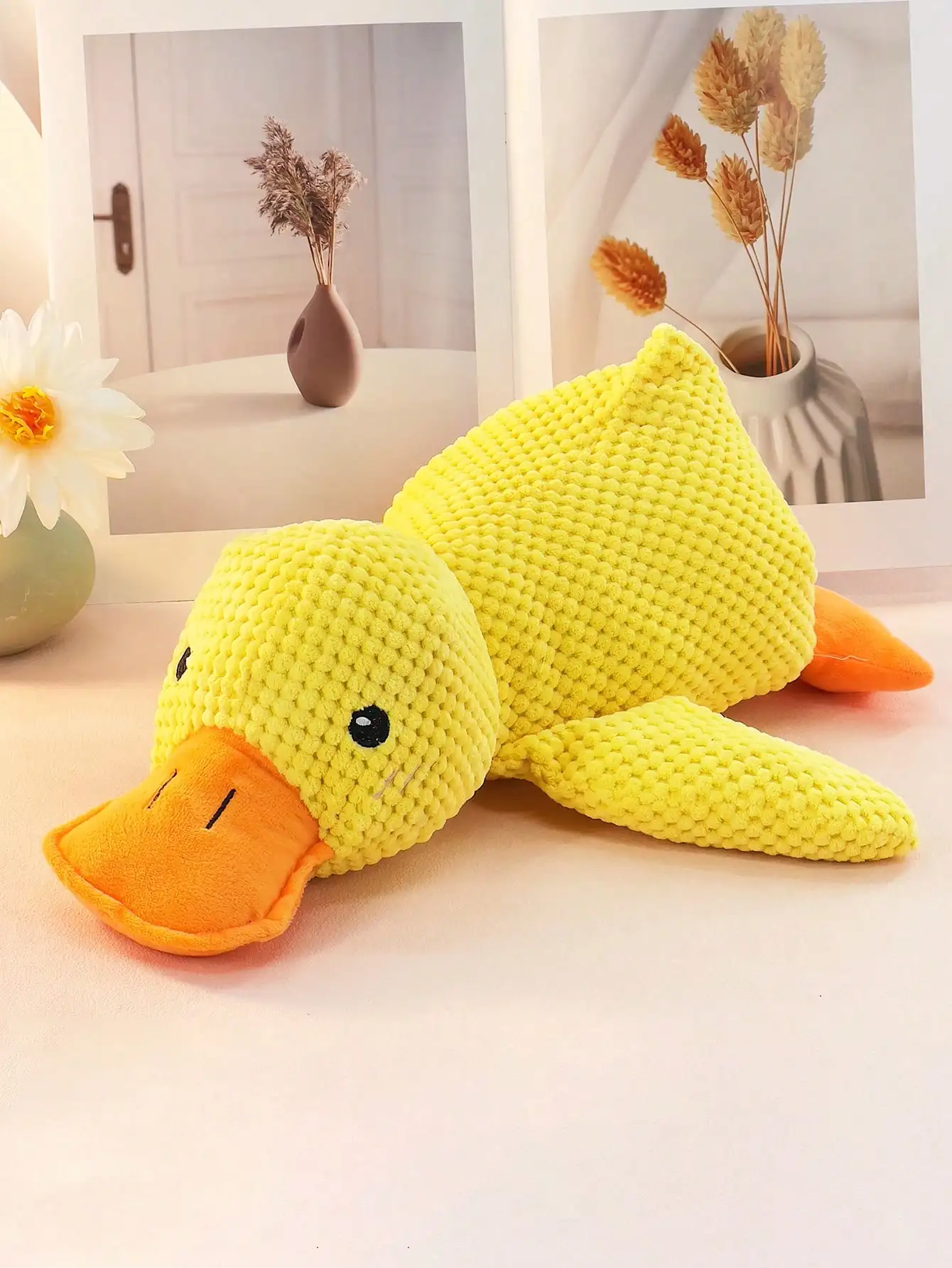 large, yellow, large duck pet stuffed toy that squashes and plays with the dog can be used as a pillow for pets only