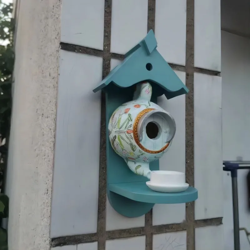 Teal teapot birdhouse and feeder patio decoration