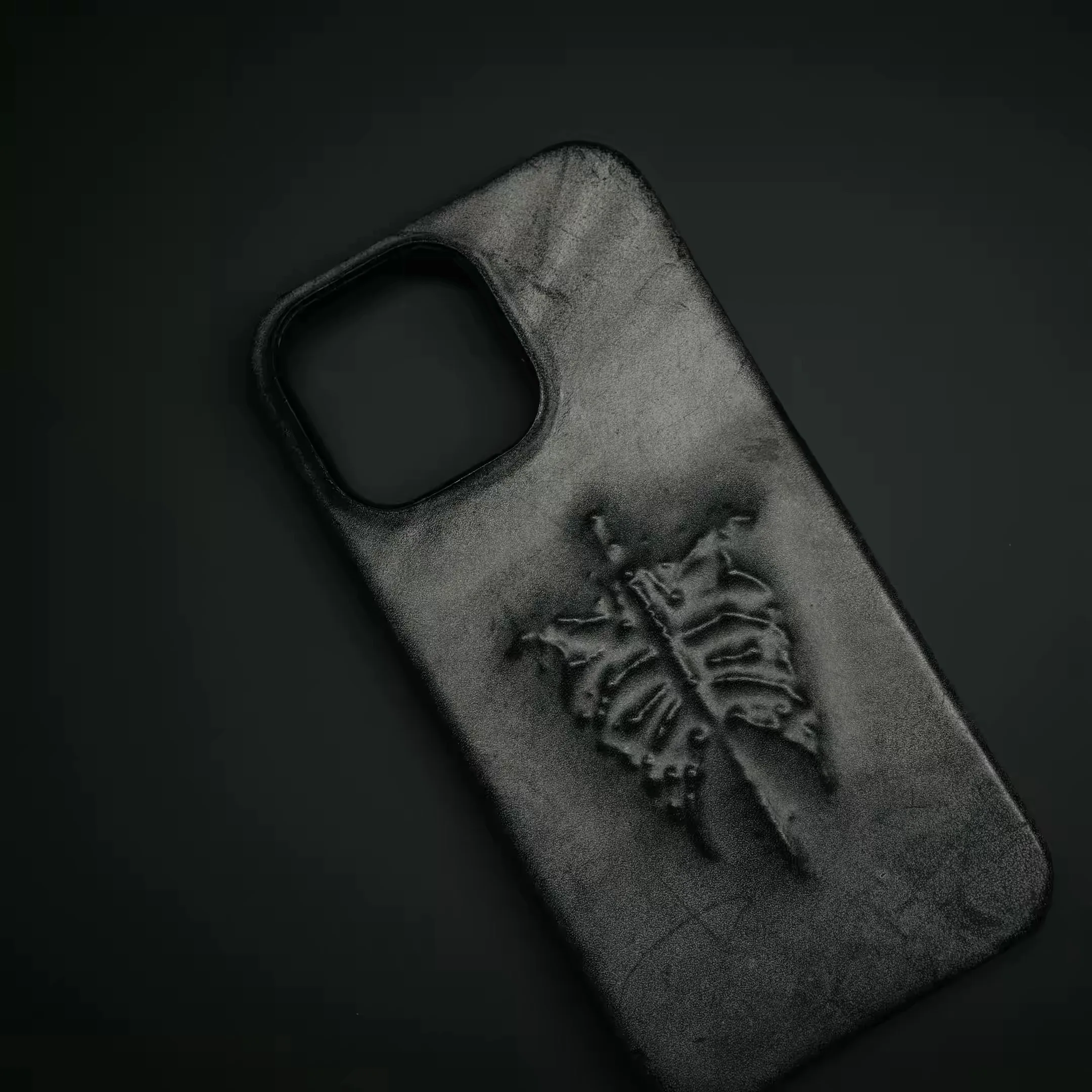 

Dark-themed black wax leather phone case for bones aesthetic sculpture design, suitable for iPhone.