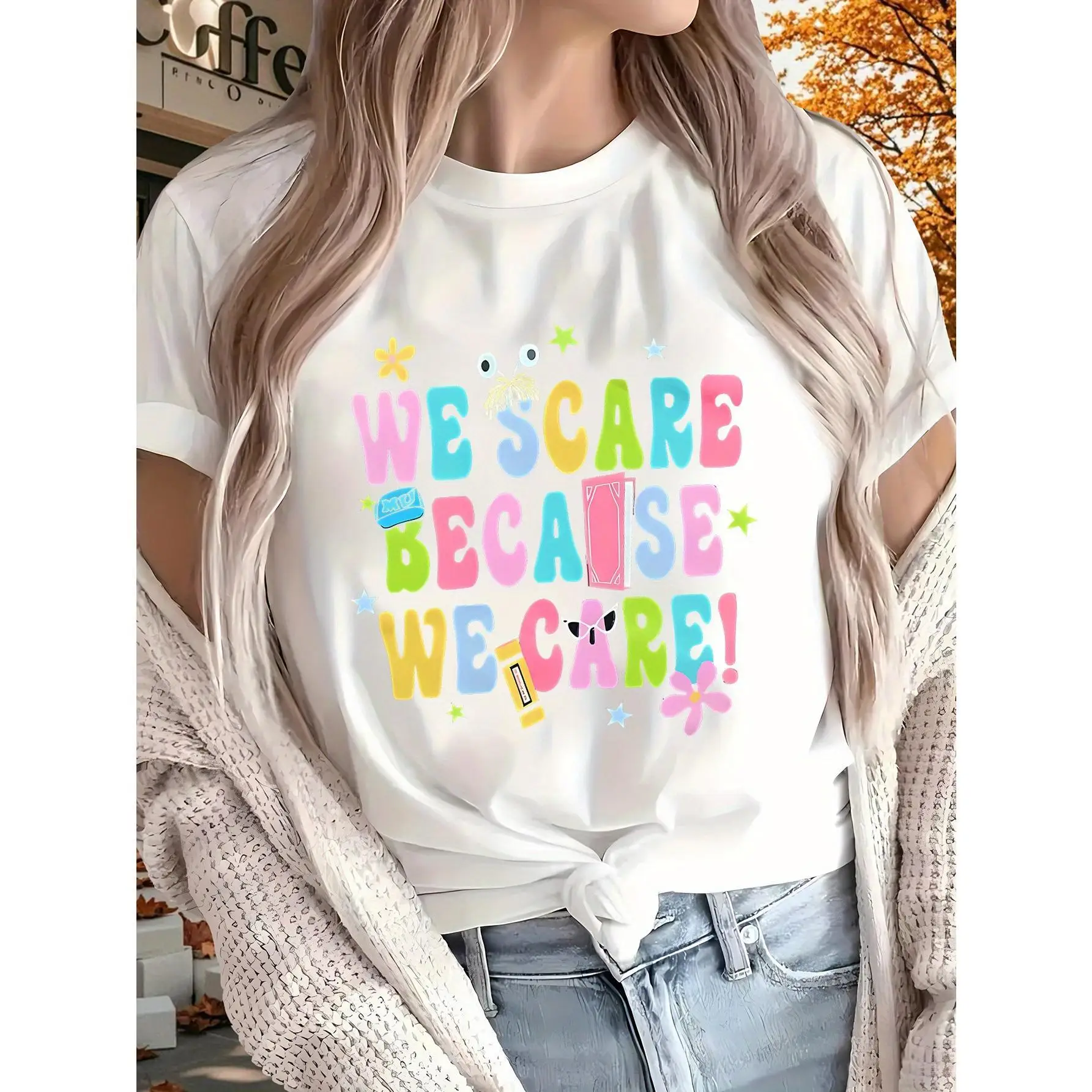 

Because We Care Women's Short Sleeve T-Shirt - White Geometric Print with "WE SCARE BECAUSE WE CARE!" Slogan, Stars & Flowers