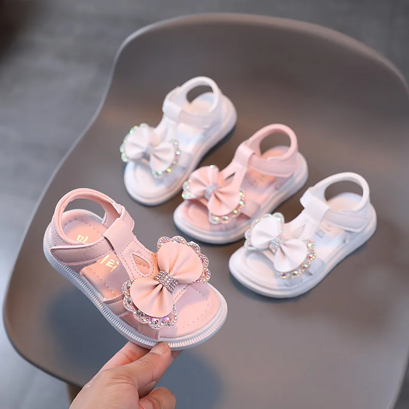 Sandal Anak Perempuan Musim Panas Sepatu Anak Perempuan Bayi Berlian Imitasi Pita Imut Sepatu Putri Hak Datar Lembut Mode Sandal Pantai Anak-anak Pink H140