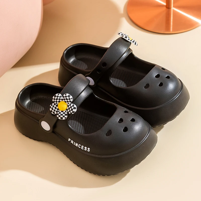 A pair of children's Mary Jane slip-on shoes with thick soles and anti-slip properties, worn as a beach shoe. QT-325-1