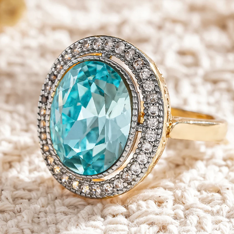 Huitan Damenring, zweifarbig, mit funkelndem blauen Zirkonia, modisches Hochzeits- und Party-Accessoire, edler ovaler Schmuck