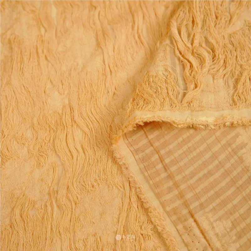 Orange fringed linen cut-out fabric for dresses shirts and evening gowns a designer's fashionable
