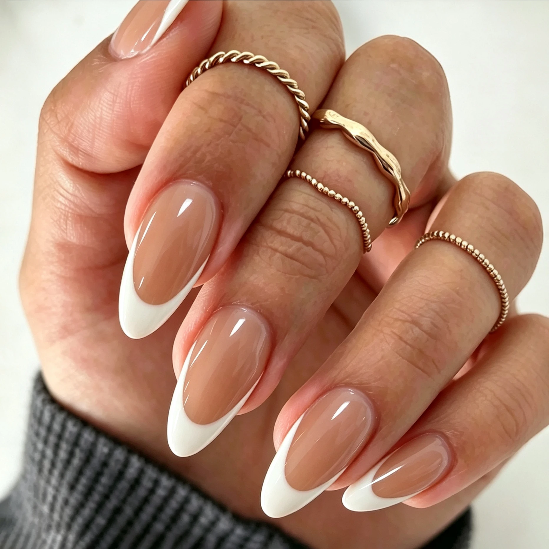 Full set of 240‑piece medium almond fake nails‑caramel nude base with white V‑shape french tip, glossy finish, reusable false pr