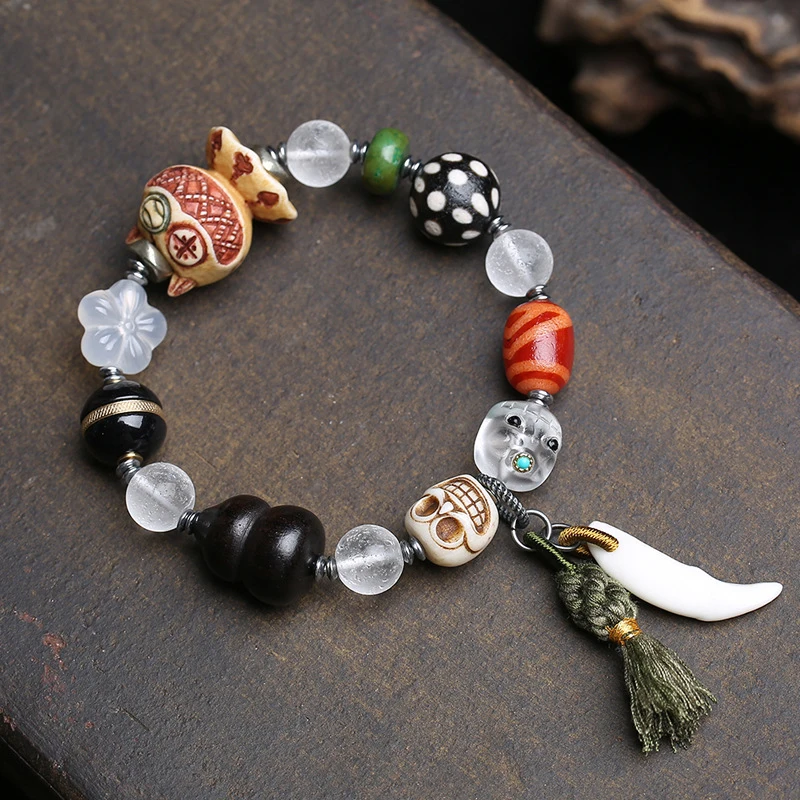 

Natural agate glass multi-bead bracelet with vintage deer antler, Kintsuke ebony, gourd, and Dzi beads accessories