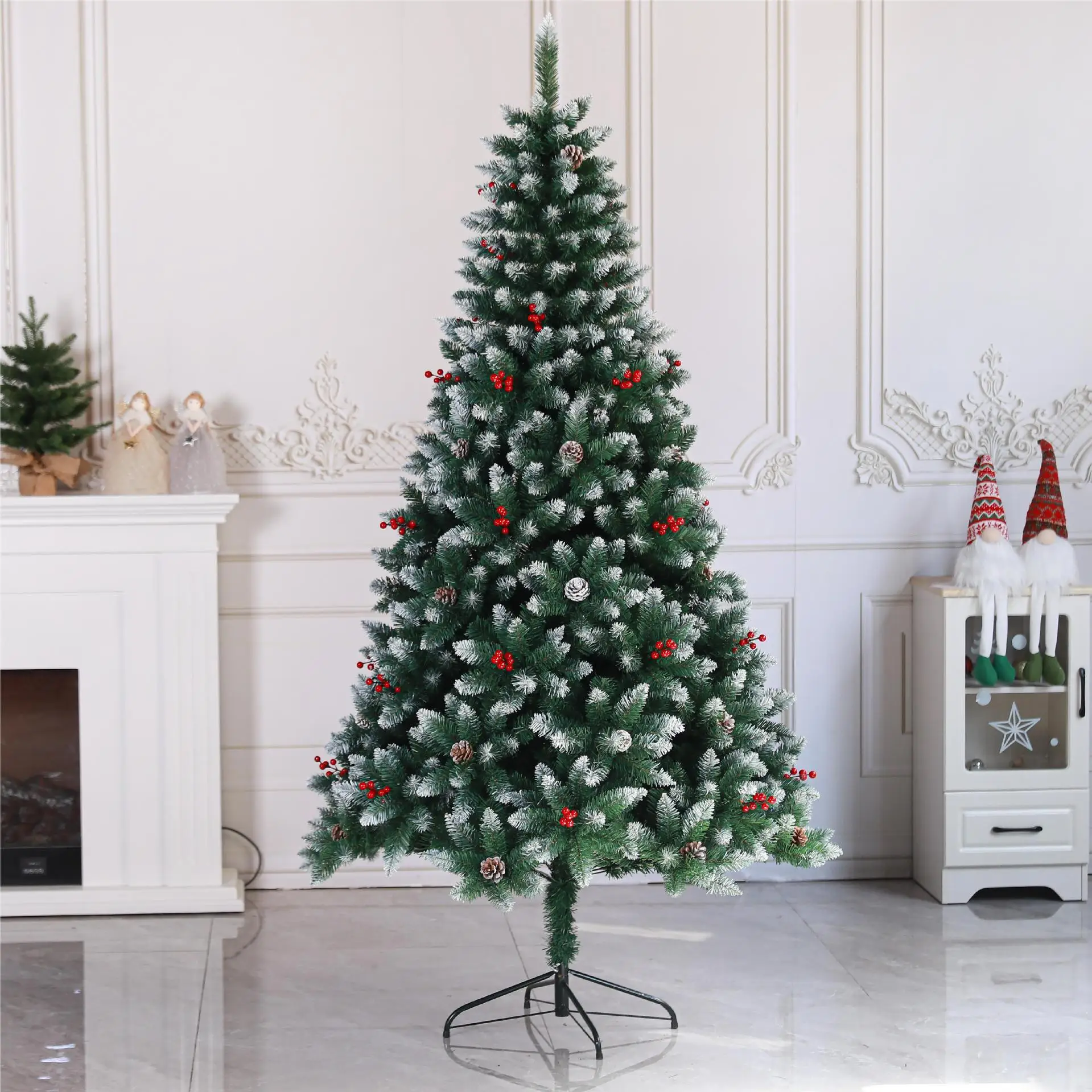 Artificial green Christmas tree with red berries and pine cones