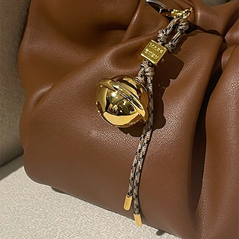 

MARSEVE flash party series golden bell bag hanging exquisite high-end metal creative pendant accessories