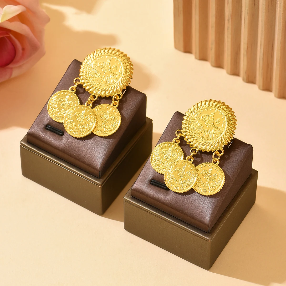A pair of retro ethnic-style circular coin-pattern pendant design brooches as accessories for the bridal wedding dress a corsage