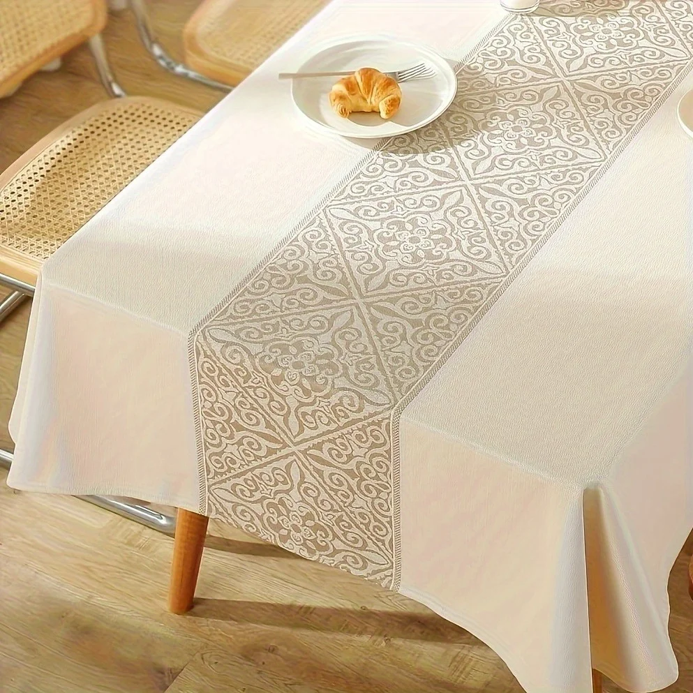 The elegant linen tablecloth features geometric floral patterns on a rectangular table.