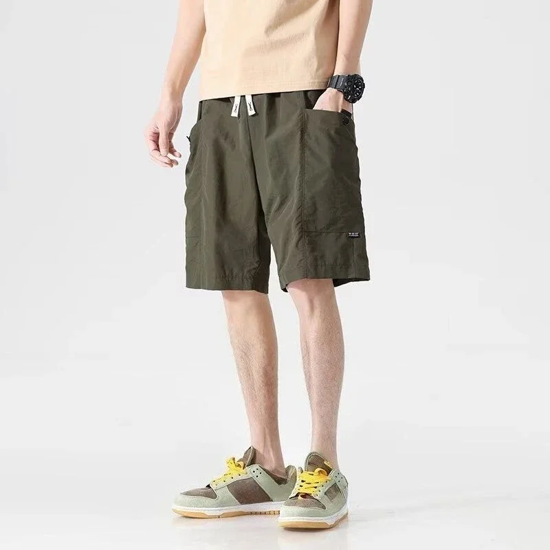 Celana Pendek Pria Bermuda dengan Saku Tali Tarik Celana Pendek Kargo Pria Setengah Panjang Solid Pakaian Vintage Pinggang Elastis Baru Dalam Lebar