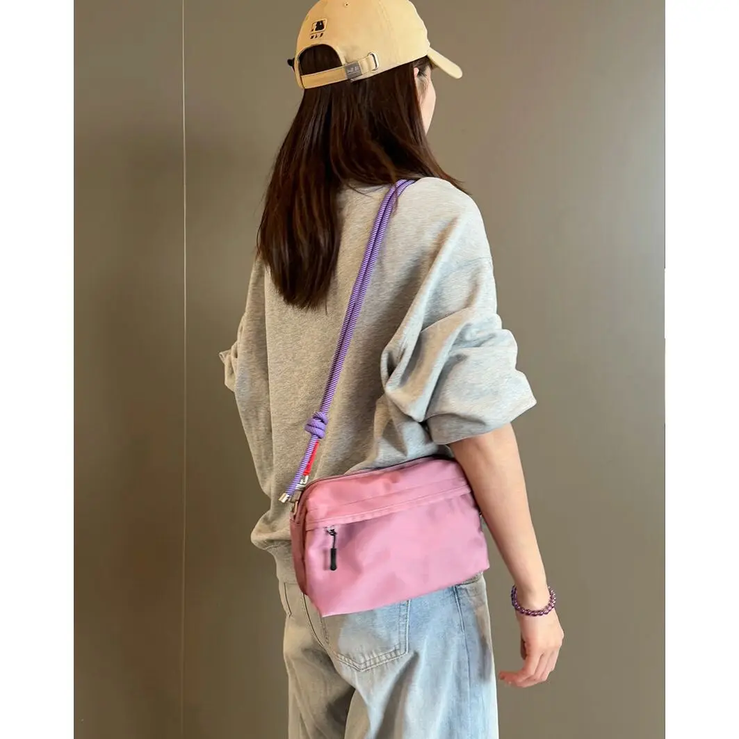 Versatile Small Square Bag with Multiple Compartments Casual Waterproof Camera Bag Made of Nylon in Pastel Worn Crossbody.