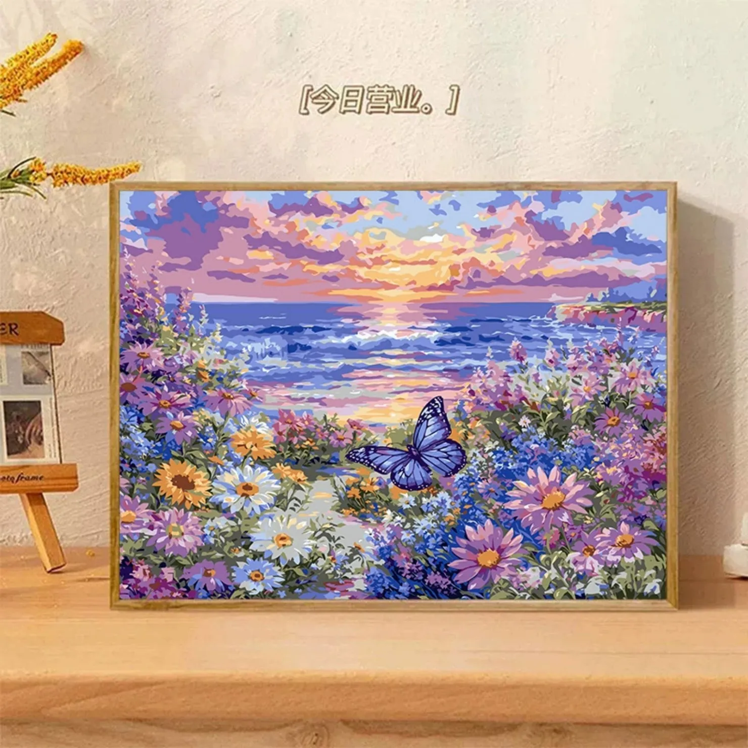 300042-Blue butterfly rests on daisies by sunset shore