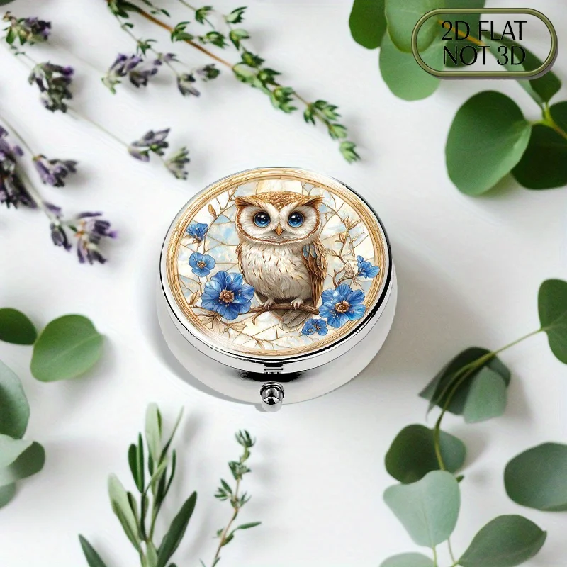 A flat, portable, round metal pill box, designed with a cute owl pattern, with sparkling eyes surrounded by flowers, is perfect for organizing daily medication, vitamins, and small accessories, making it ideal for travel and as a gift for loved ones during summer celebrations.