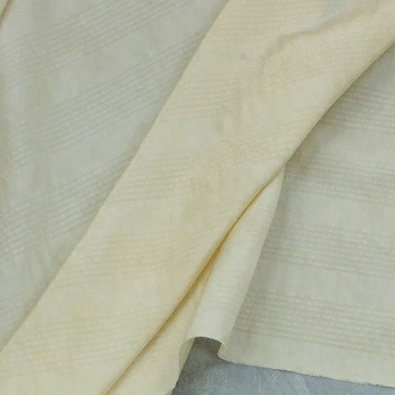The traditional artist-dyed tussah silk blended fabric in apricot color is a designer for Chinese Hanfu and cheongsam clothing