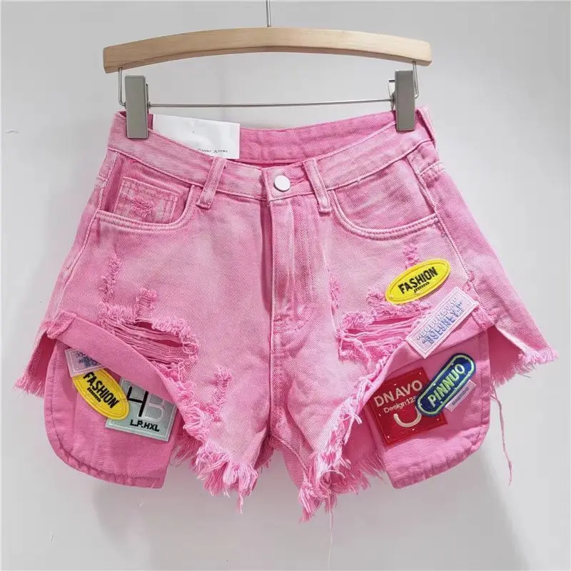 新しいトレンドのレディース スプライスドホール バーリーエッジ デニムショートパンツ 2026 夏 ファッション ハイウエスト Aライン ショートパンツ 女性用