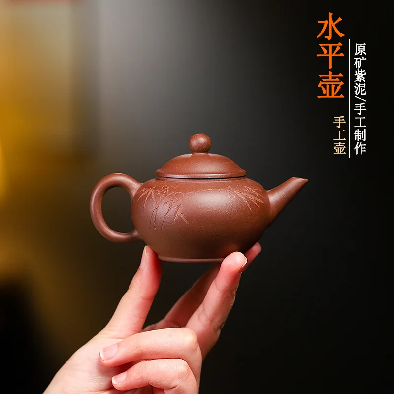 

Modern minimalist hand-painted purple clay teapot with lid, black tea and black tea brewing utensil, purple clay teapot