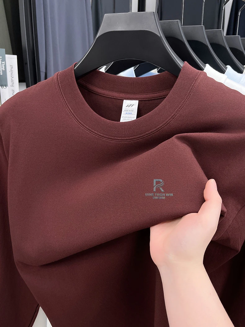 T-shirt a maniche lunghe da uomo in puro cotone di fascia alta 2025 Nuova primavera e autunno inverno girocollo allentato con cappuccio tinta unita da uomo