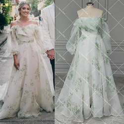 Bloom Vestidos de novia con estampado floral personalizados Mangas largas de globo Volantes de organza Tren fluido Vestido de novia festoneado con hombros descubiertos