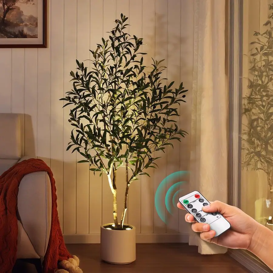 

Искусственное оливковое дерево, высотой 1,5 м, с дистанционным управлением светодиодными прожекторами, в круглой белой цилиндрической кашпо для современного интерьера.