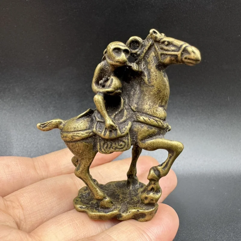 Small ornaments: standing, little, bronze monkey riding a horse, collectible items