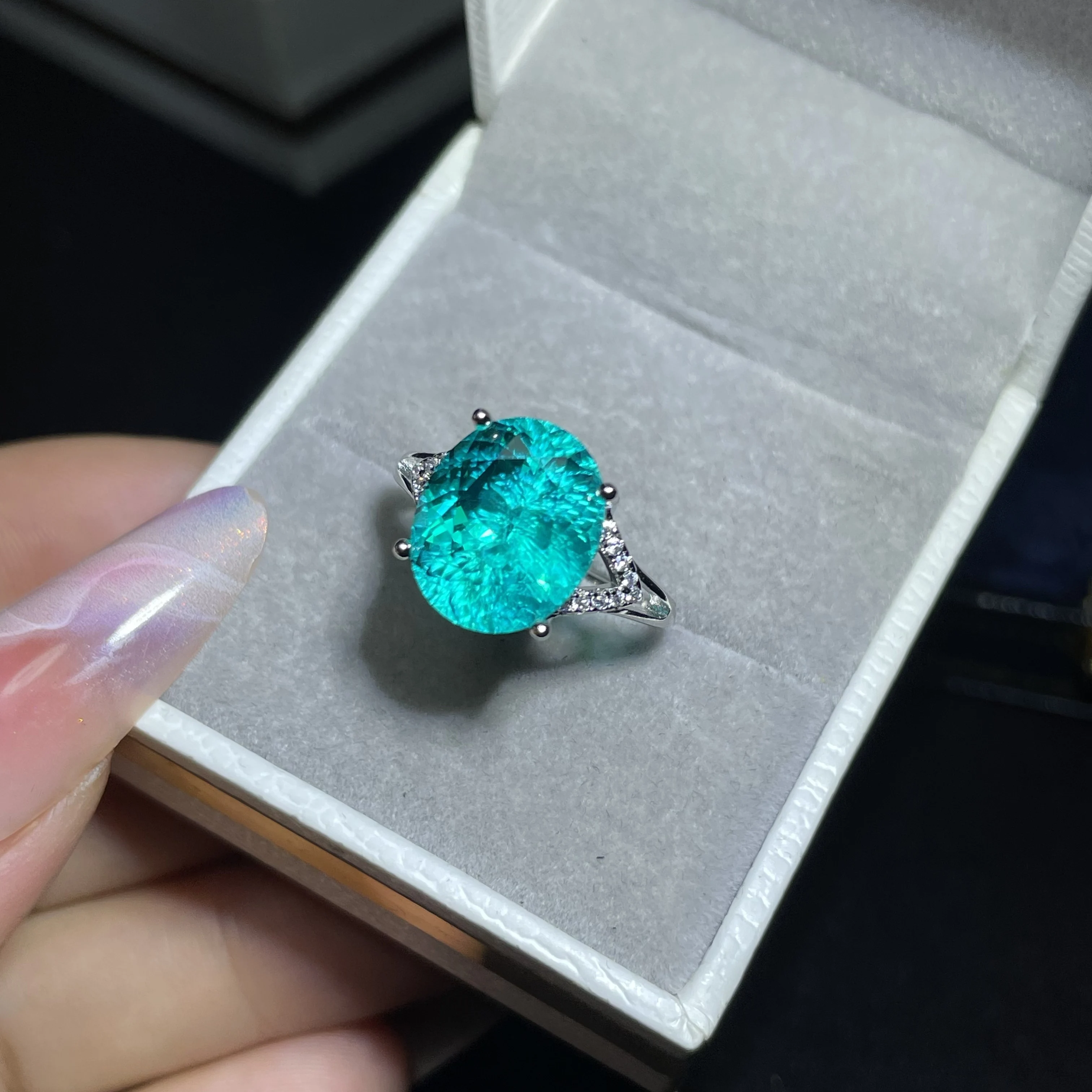 Electric blue Paraiba diamond ring, featuring an oval single stone with diamond accents, as a vintage-inspired gift