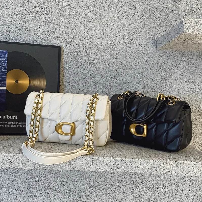 

Crystalline Geometric Bag with Faceted Details and Rotating Hardware for Rooftop Soirees Manifesting Architectural Allure