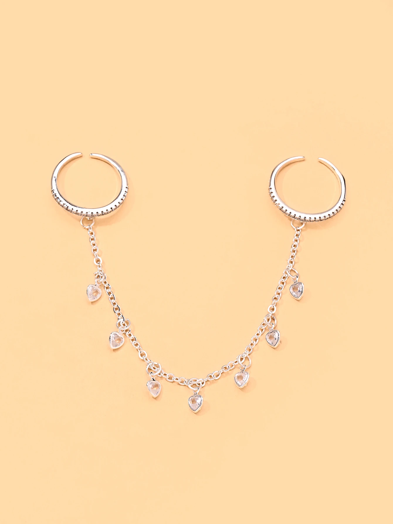 A minimalist, stylish, and versatile women's ring featuring a heart design and tassels—perfect for evening wear.