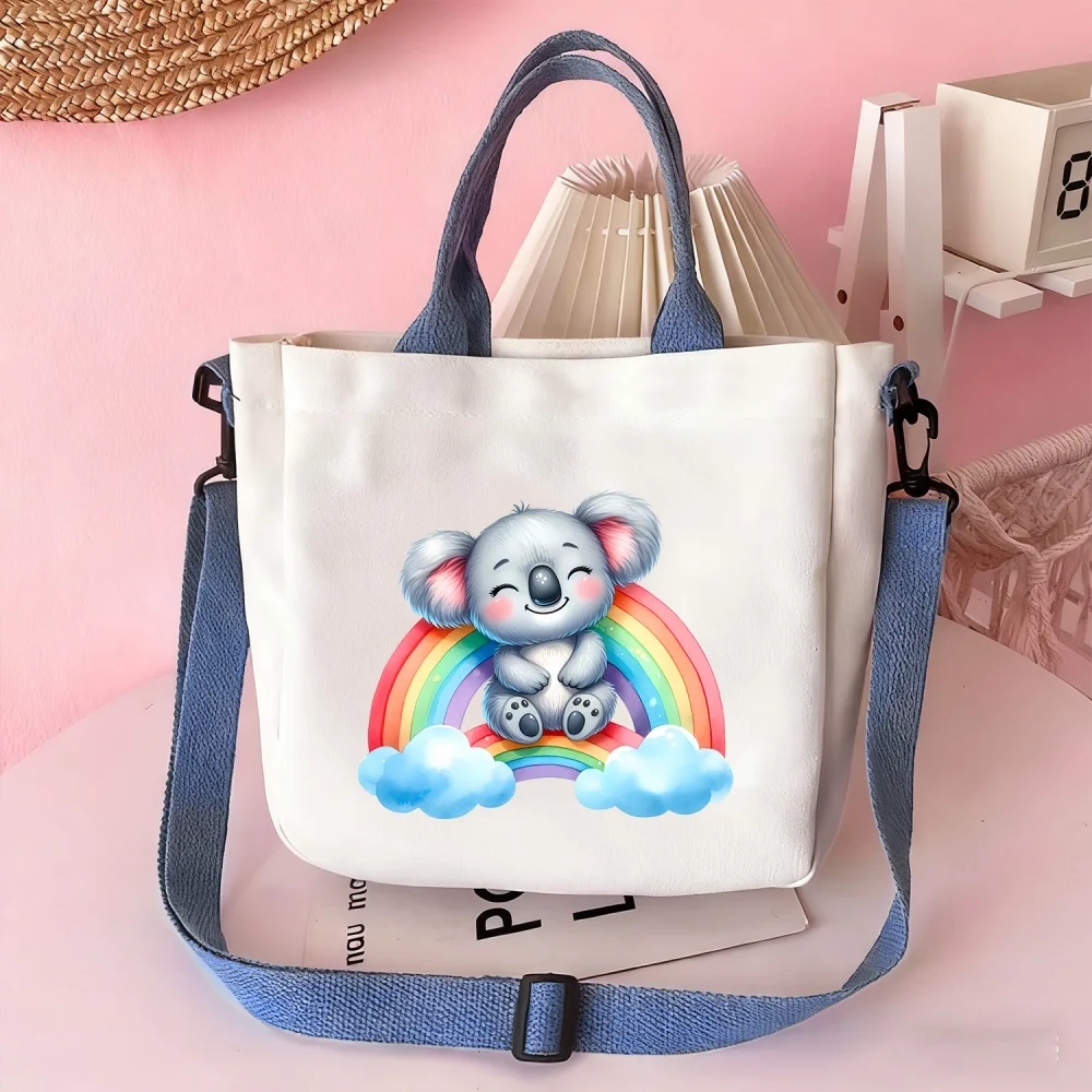 Handbags and crossbody bags featuring a koala-on-a-rainbow design, perfect for travel and organizing cosmetics.