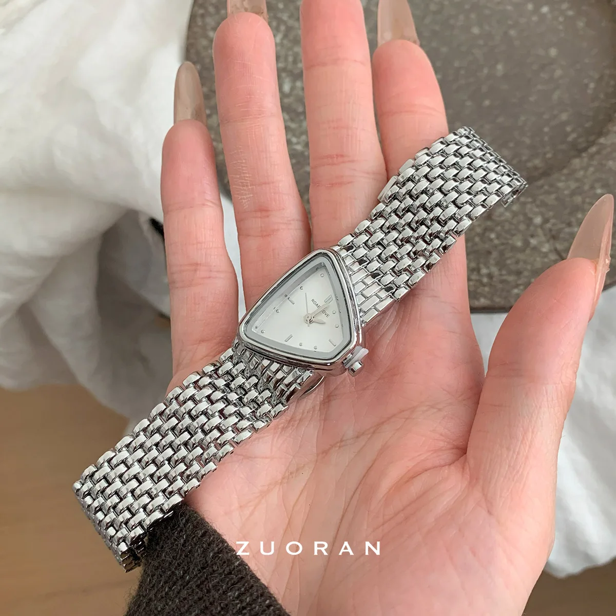 New luxurious and sophisticated silver quartz watch with uniquely shaped dial, a versatile and stylish accessory for women.