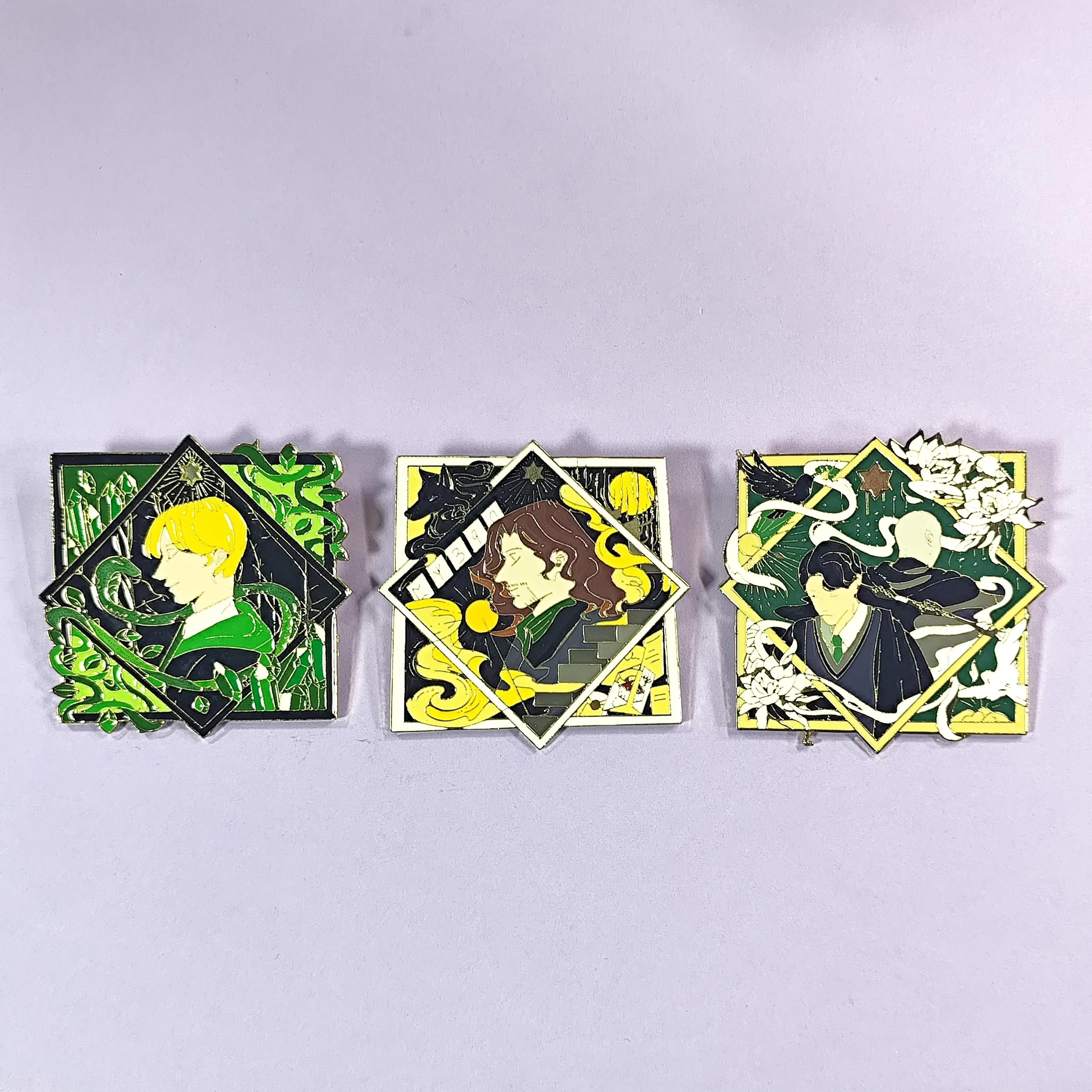 Three square enamel pins: intricate designs, colorful detailed frames. Great for adding artistry to bags, jackets.