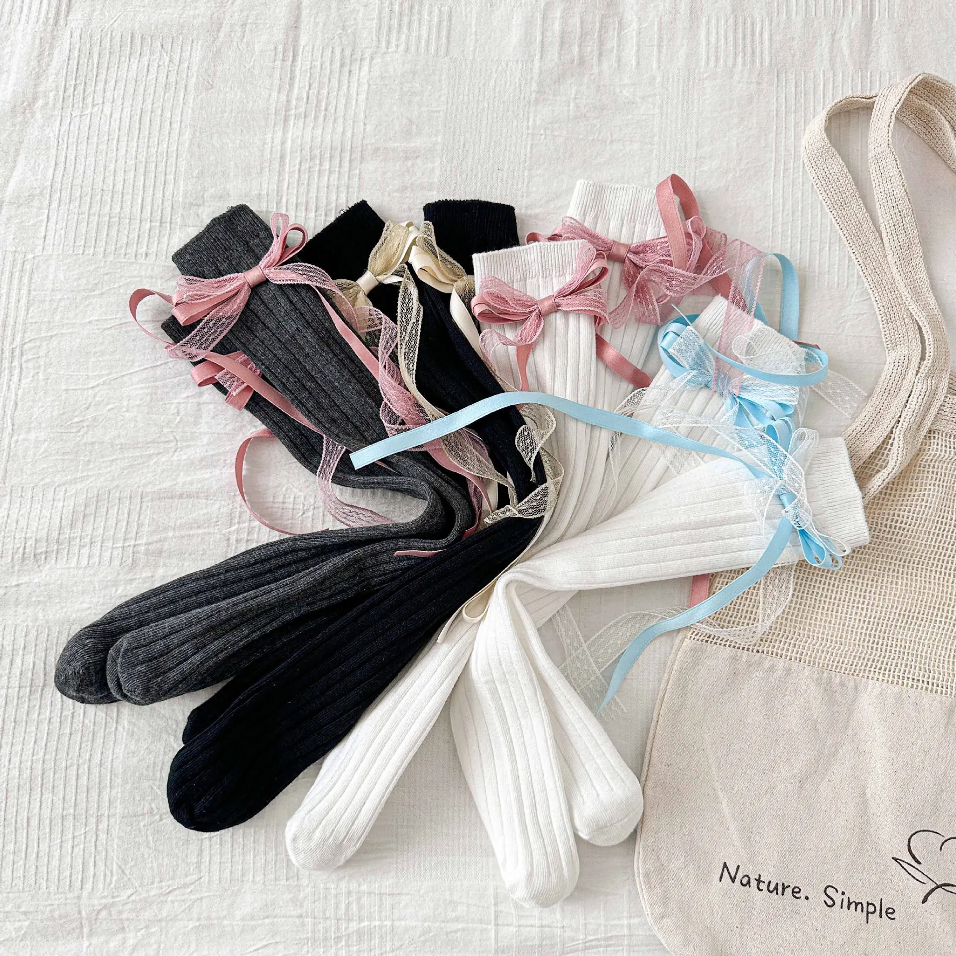 جوارب ربيع 2026 للأطفال البنات جوارب حلوة متوسطة الطول للفتيات جوارب طويلة بعقدة على شكل فيونكة على طراز القرآن جوارب للأطفال بشرابة #1