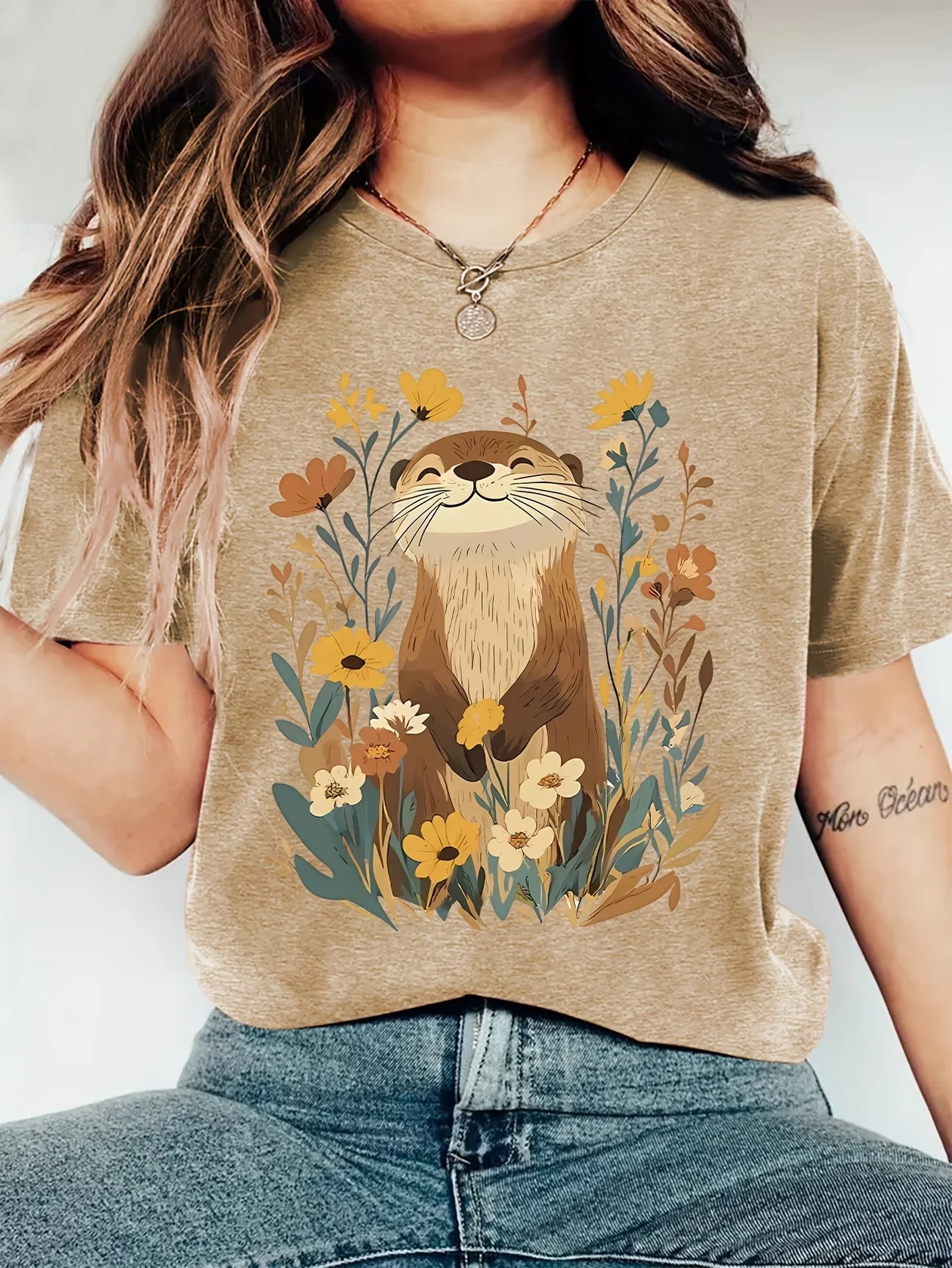 Soft, lightweight fabric, classic crew neck, and short sleeves offer all-day comfort. The charming smiling otter surrounded by w