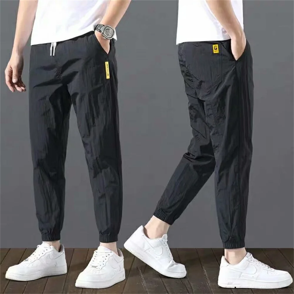 Pantaloni da uomo primavera estate pantaloni da Jogging sportivi in seta di ghiaccio abbigliamento da uomo traspirante pantaloni larghi Casual moda Streetwear