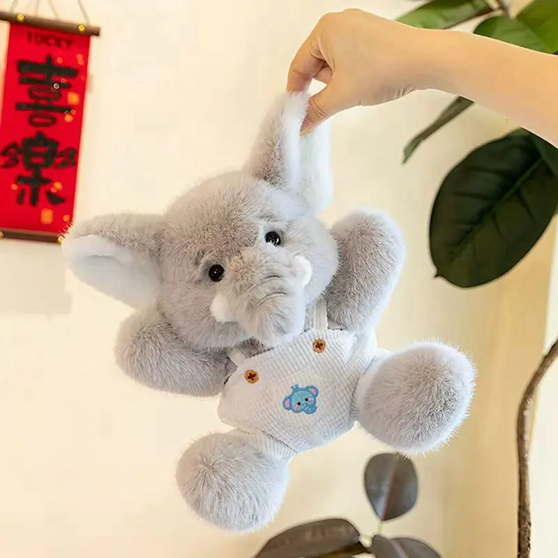 23 ซม.กระเป๋าเป้สะพายหลังสไตล์ใหม่ช้างตุ๊กตาของเล่นขนาดเล็กตกแต่งตุ๊กตาช้างสัตว์วันเกิดและคริสต์มาสของขวัญเด็ก