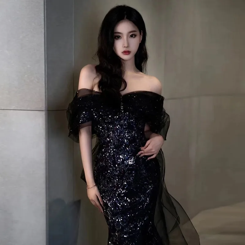 The new black will preside over a one-shoulder sequined fishtail slimming long graduation dress