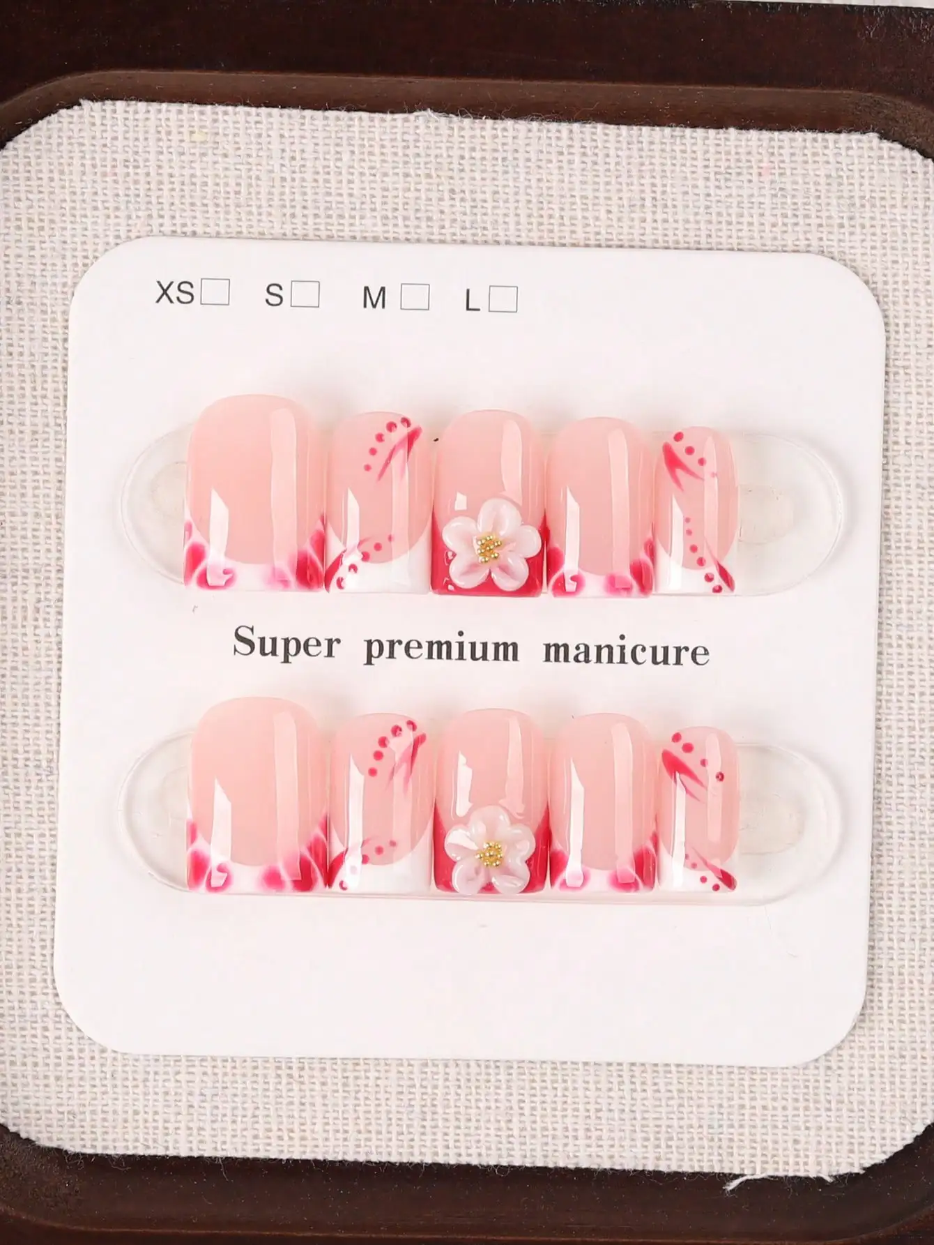 

10 Short Square-Shaped Press-On Nails, Gentle Girly Style, Nude Blush Base Color with Pink Gradient French Tips, Hand-Painted Red Line Decorations, Complemented by 3D White Flowers and Small Gold Beads, Glossy Finished