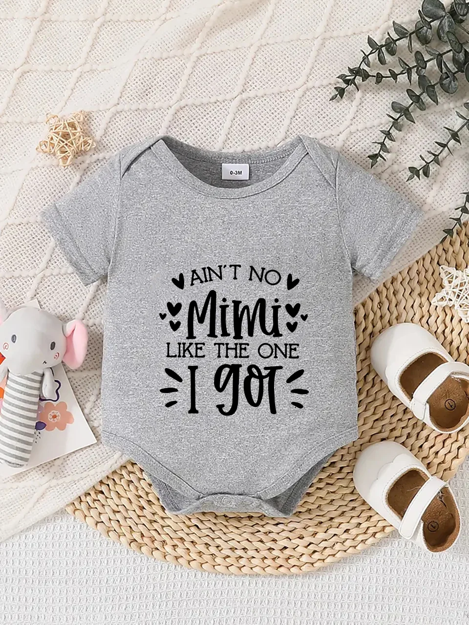 Playful letter-printed baby short-sleeve triangle bodysuit. Button closure for easy dressing, machine washable