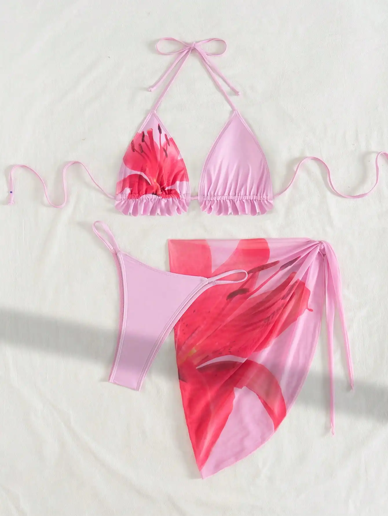 

Pink Floral Triangle Bikini Set With Ruffled Halter Top, Thong Bottom, And Sheer Wrap Skirt For Beach Vacation