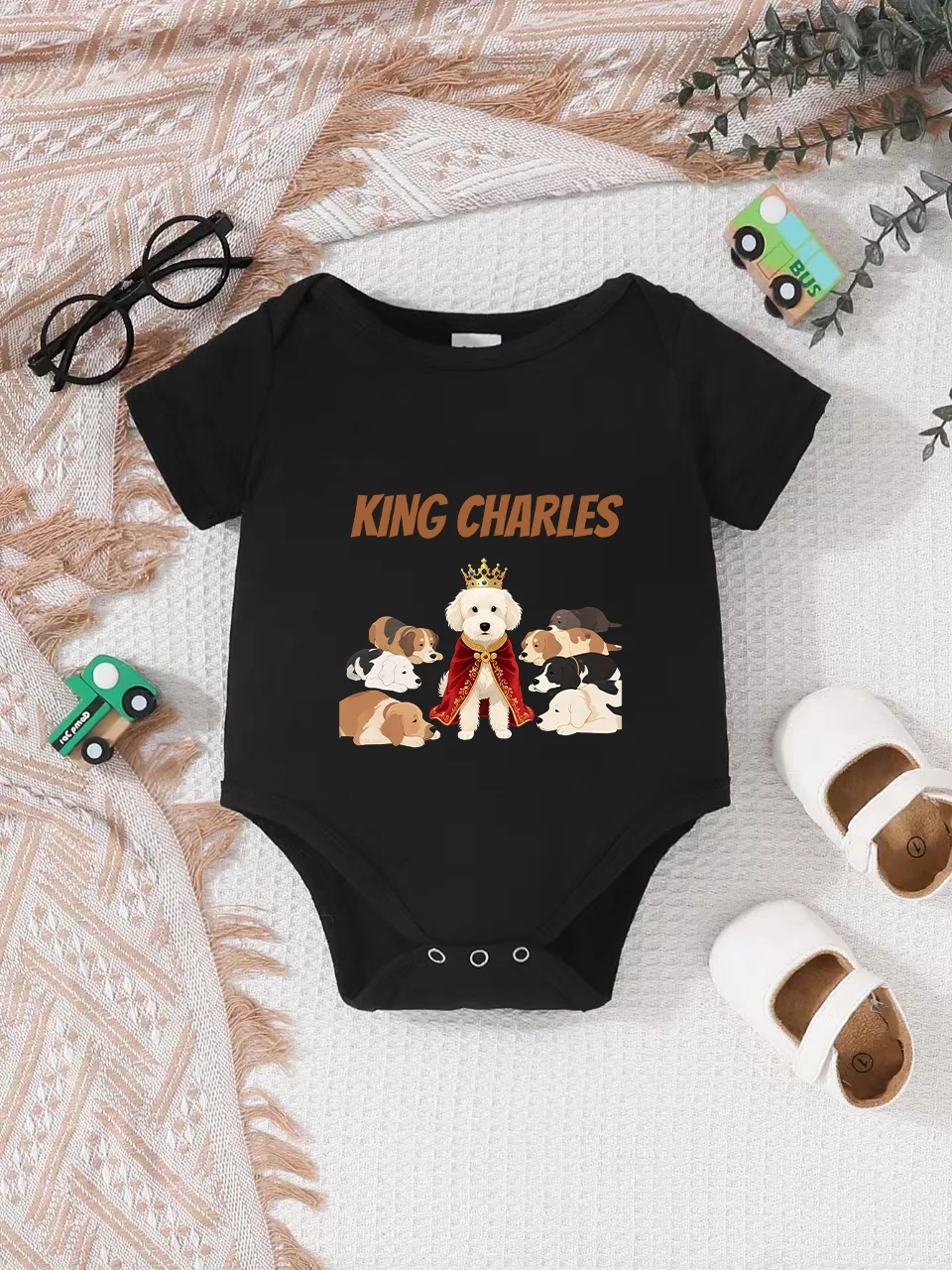 Playful letter-printed baby short-sleeve triangle bodysuit. Button closure for easy dressing, machine washable