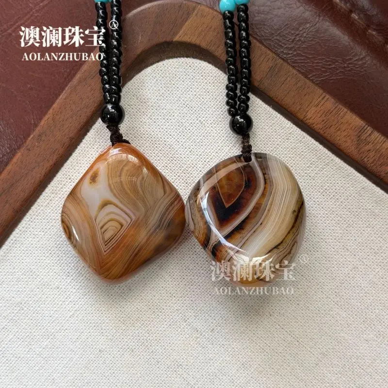Natural silk-wrapped agate striped pendant pebble-shaped rain flower stone hand-held ornament raw stone polished with silk ag