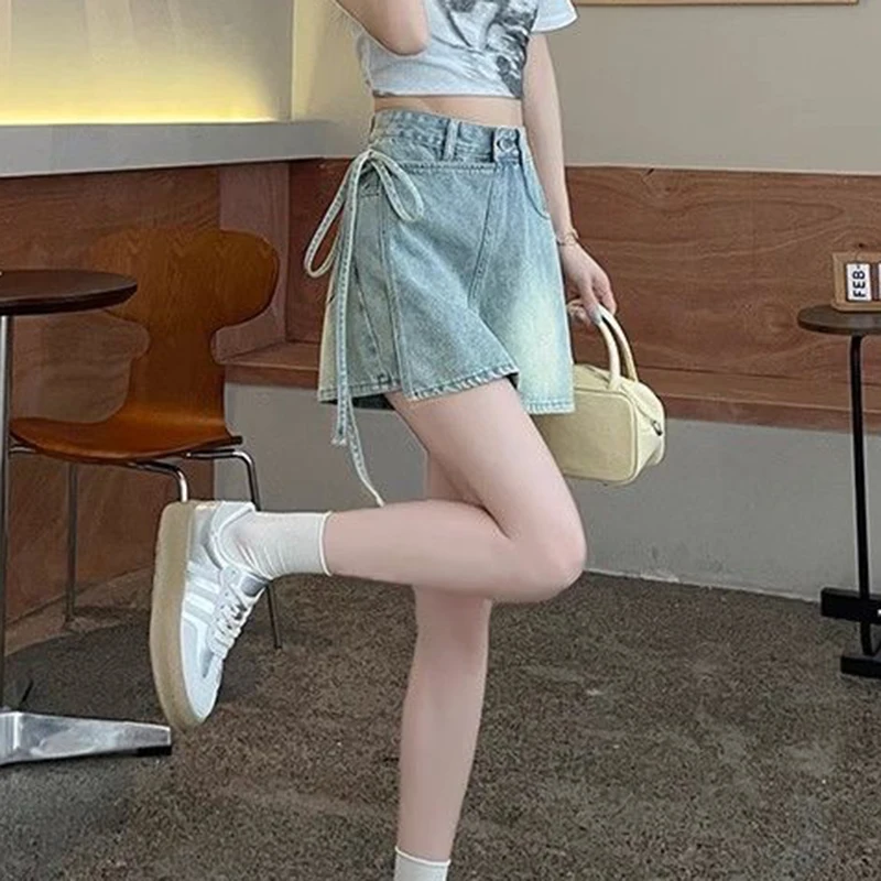 Fake two pieces of denim shorts women\'s summer new A-shaped high waist irregular western-style strap skirt slim Joker hot pants.