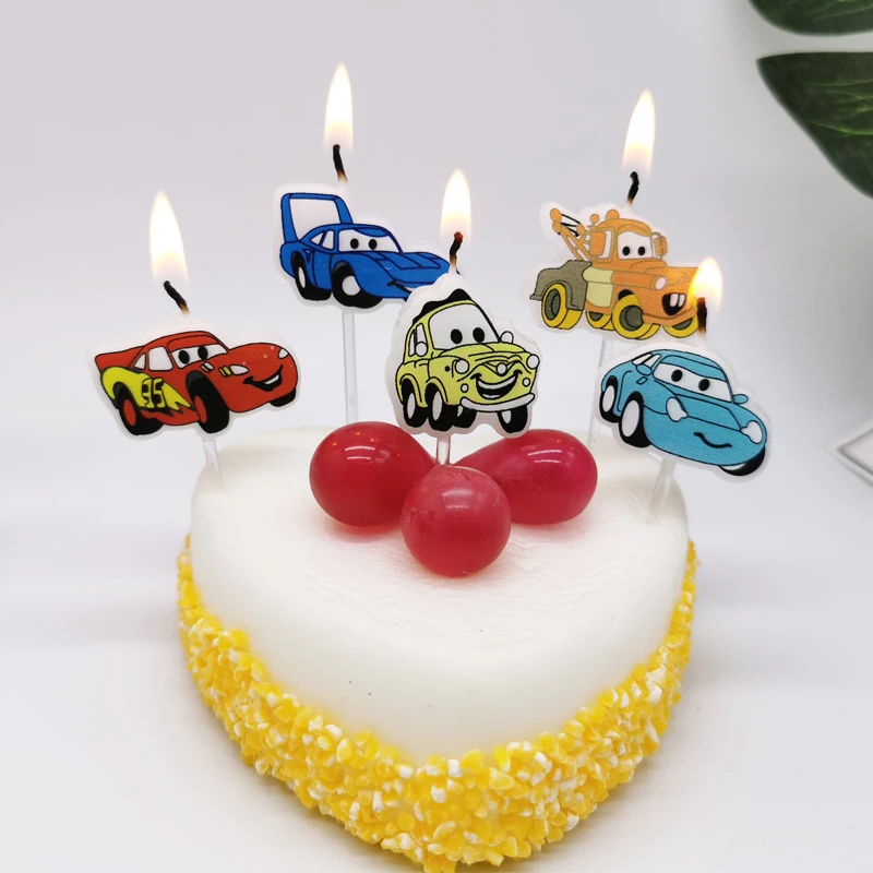 Car with smiling face, birthday candles, cartoon cake decoration