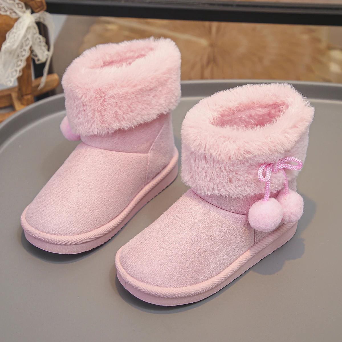 A Pair of Cute and Versatile Pink Plush Ball Snow Boots for Girls