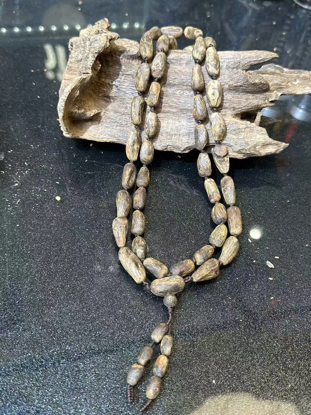 

Generation-old mother tree natural agarwood log with scarring, long strand necklace, collector-grade multi-loop, instantly sinks