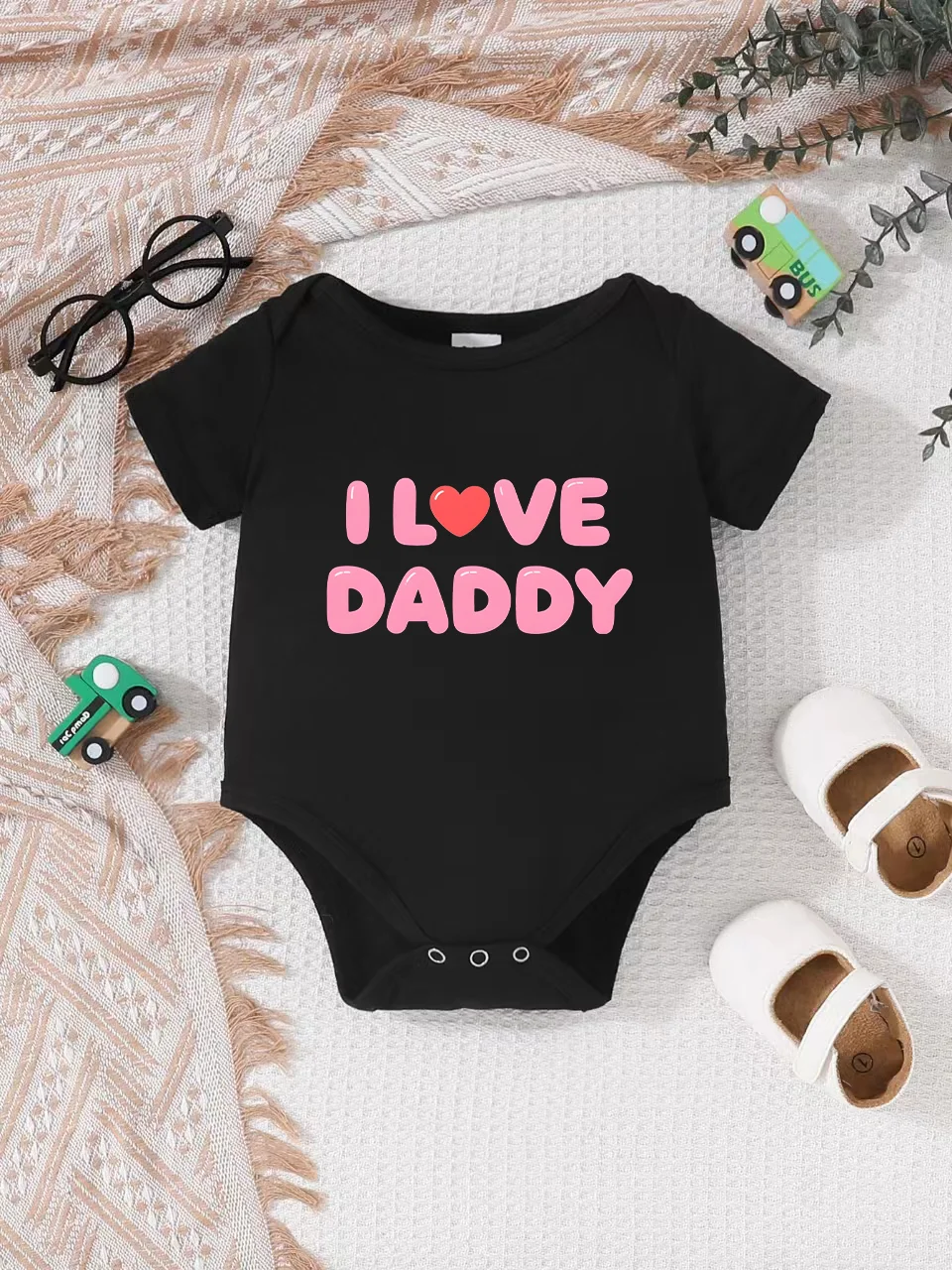 Playful letter-printed baby short-sleeve triangle bodysuit. Button closure for easy dressing