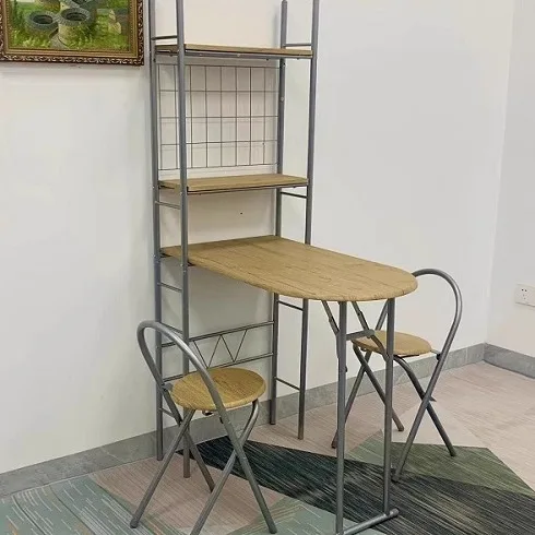 Folding tables and chairs against the wall are light and luxurious
