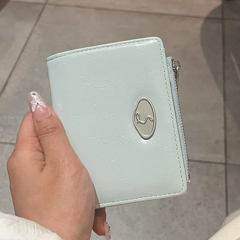 Crinkled PU bi-fold wallet, metal accent, multi-slots with ID window, side zip coin slot, stylish portable for ladies.