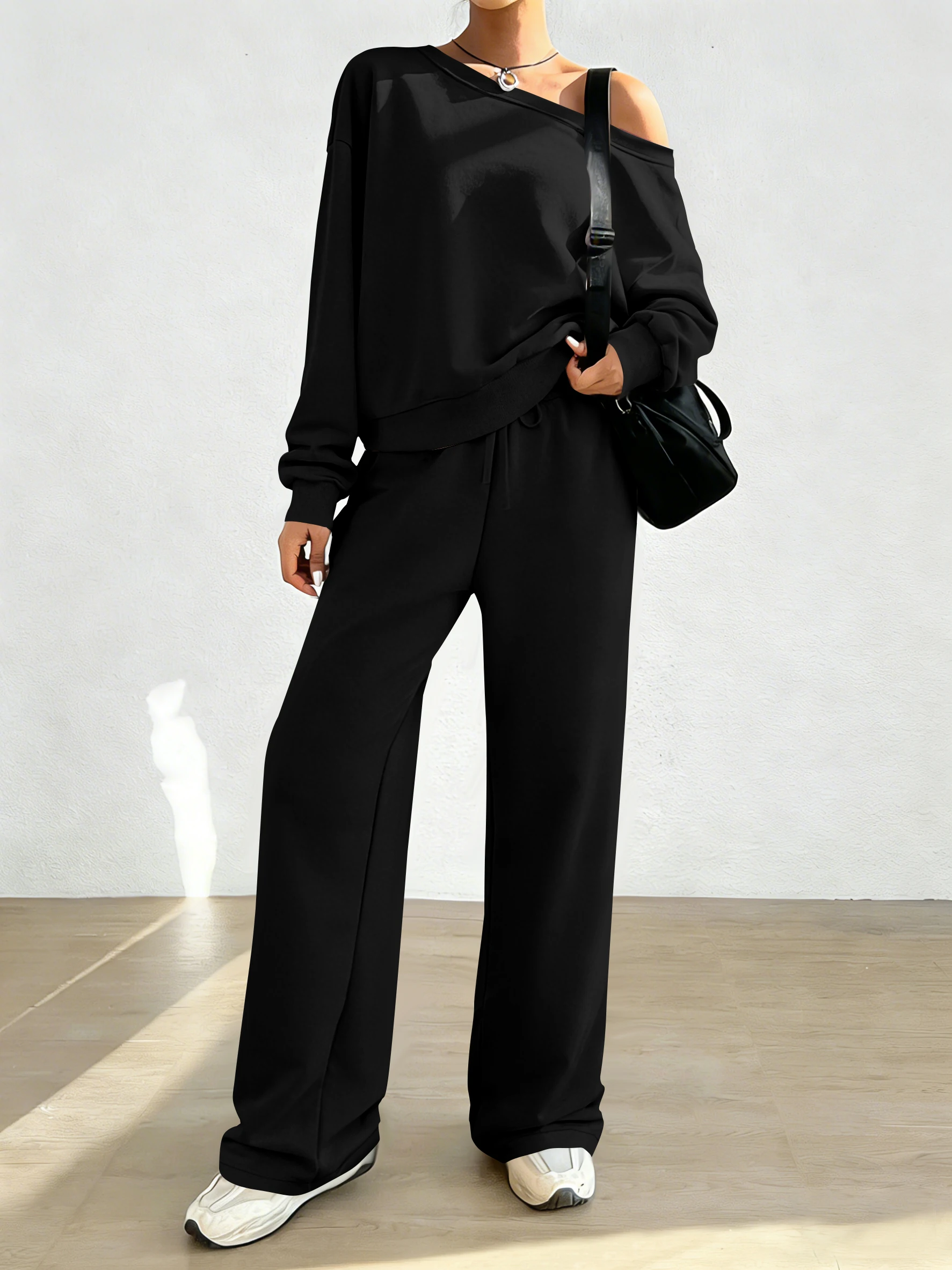 Women's fashionable two-piece set: an off-the-shoulder loose-fitting sweatshirt and drawstring wide-leg trousers.
